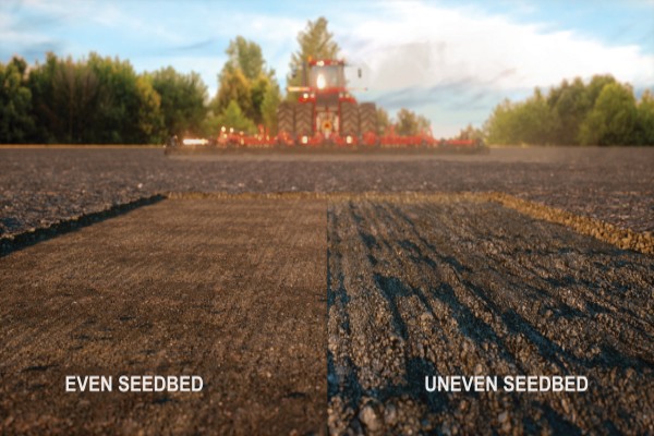 Dirt field with red combine in background.